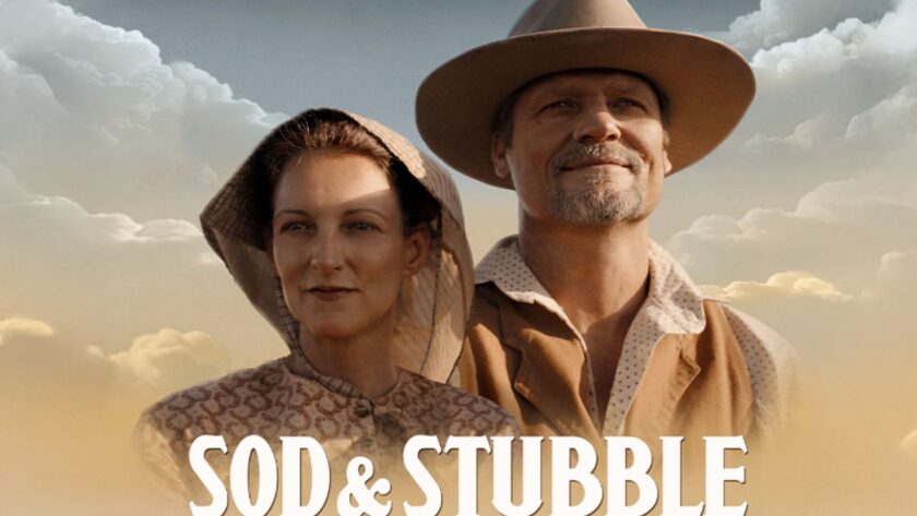 A man and woman in 19th century Western dress are backlit by a summer sky. Sod & Stubble.